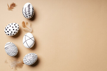 Easter eggs painted by hands on a beige background