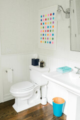 clean bright bathroom with colorful print on the wall