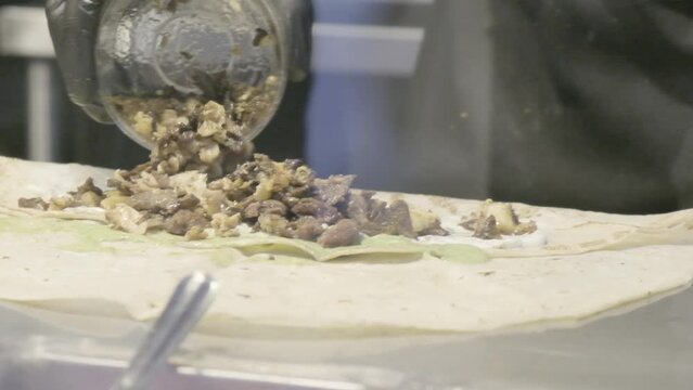 cocinero preparando comida mediterranea, mexicana, oriental, con carne, pollo, cerdo grabado en camara lenta