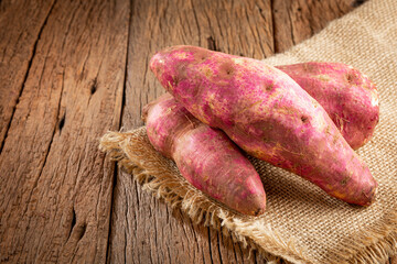Raw sweet potato on the table.