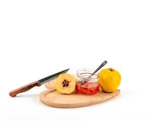 Camera view spoon and knife cutting Fresh ripe quince and jam on white background isolated.