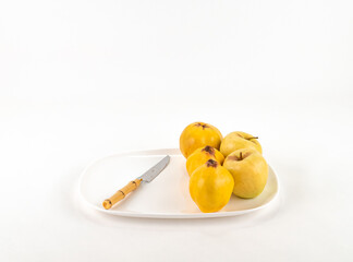 Fototapeta na wymiar Ripe quince on white background isolated. Ripe full depth of field. Fresh apple on plate