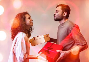 Valentine's Day concept, couple in love giving each other gifts in present boxes.