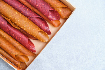 Fruit and berry pastille, dessert with nuts and seeds in a box.
