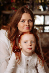 Portrait of mom and daughter woman with red hair. Daughter with red hair and freckles. Concept of mother's day, motherhood, family.