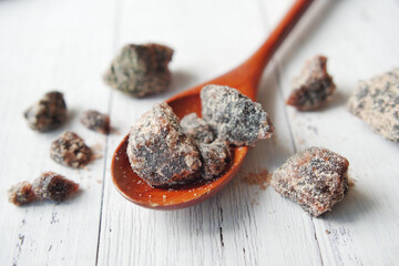 Himalayan black salt rock crystals, Kala Namak in a container on table 