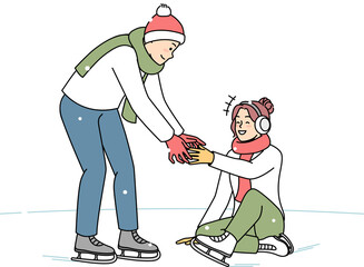 Caring man help woman on ice rink