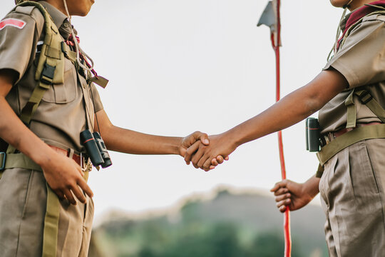 Boy Scout Shakes Hand, Boy scouts working on mountains nature adventures and travel