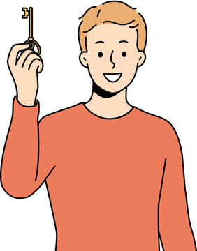 Smiling man holding key to new house