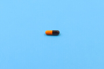 A pill or medicine on a blue background