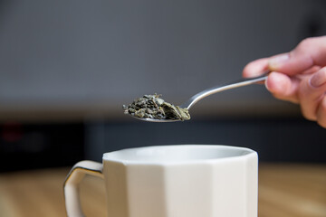 green tea on a metal silver spoon