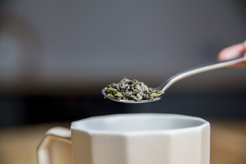 green tea on a metal silver spoon