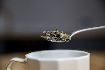 adding green tea to the cup