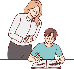 Teacher control pupil writing in notebook