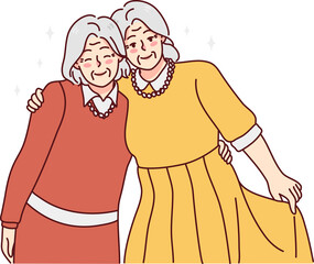 Happy elderly women friends hugging