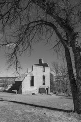Historic building façade on old homestead in black and white 