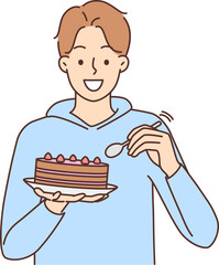 Smiling man eat cake with spoon