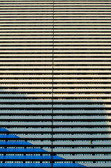 Skyscraper windows, horizontal lines, beige and blue tones
