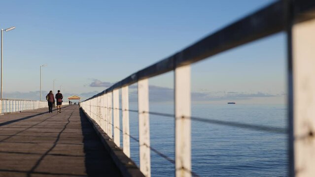 Couple and Mother Walking on Jetty in Semaphore during Morning Light
