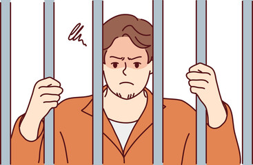 Angry man criminal behind jars in prison