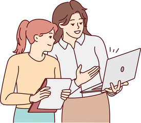 Businesswomen brainstorming working on laptop