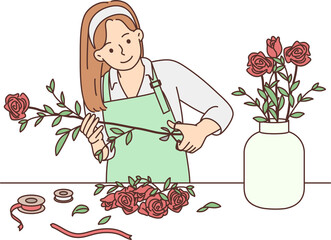 Female florist working with flowers in workshop