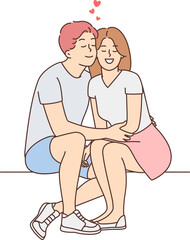 Happy couple sit outside hugging