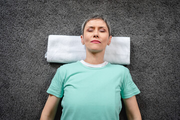 One senior caucasian woman practice restorative yoga at home