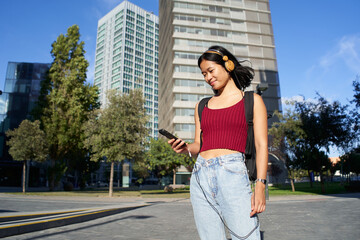 Fototapeta premium Young beautiful asian woman using smart phone and headphones. High quality photo