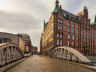 historic Red Brick Buildings and cobblestone streets bridge on St Annenfleet in Hamburg, Germany