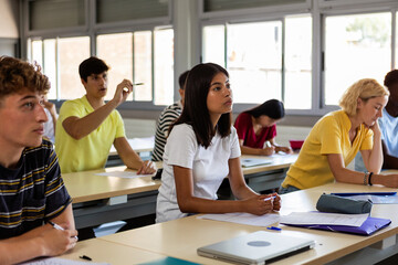 Group of young high school multiracial students in class. Education classroom lifestyle concept