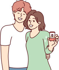 Young couple of man and woman stand in embrace showing box with wedding ring. Vector image