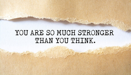 You are so much stronger than you think. Words written under torn paper. Motivation concept text.