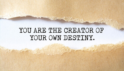You Are the creator of your own destiny. Words written under torn paper. Motivation concept text.