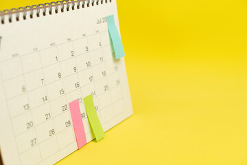 close up of calendar on the yellow table background, planning for business meeting or travel planning concept