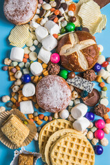 Fototapeta na wymiar .An assortment of unhealthy foods that are bad for the figure, skin, heart and teeth. Fast carbohydrate food. Space for text