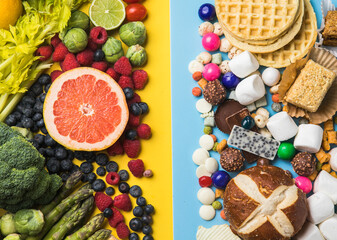 Healthy and unhealthy food background from fruits and vegetables vs fast food, sweets and pastry top view. Diet and detox against calorie and overweight lifestyle concept.