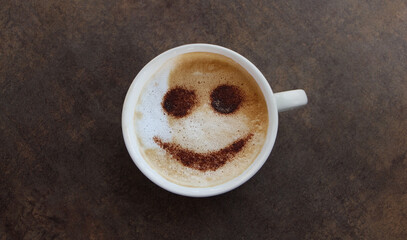 Cup of cappuccino coffee with happy face