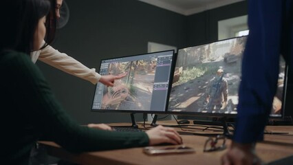 group of women in office of video game design company, IT specialists discussing
