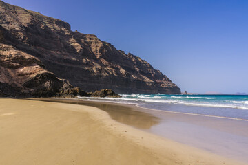 Fototapeta na wymiar The beach at Orzola in Lanzarote near the cliffs of the Punta Fariones.