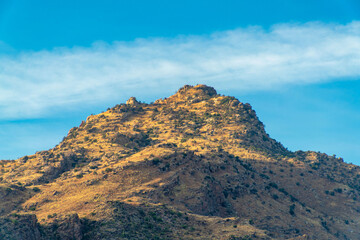 Lone moutain peak in the sonora desert of southwestern america in united states arizona with foliage and grasses
