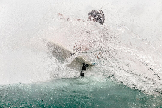 Man surfboarding on wave in sea