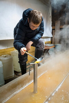 Boy preparing maple syrup,&acirc;&euro;&nbsp;Little&acirc;&euro;&nbsp;Suamico, Wisconsin, USA