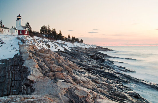 Pemaquid Point lighthouse catches the first rays of the morning sun on a cold winter day, Maine.