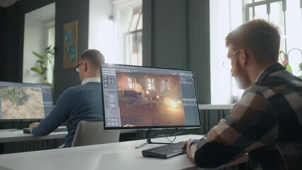 game development department, men are sitting at table with powerful computers, creating 3D graphics