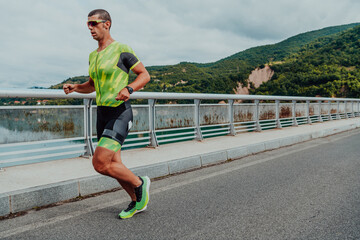 An athlete running a marathon and preparing for his competition. Photo of a marathon runner running in an urban environment