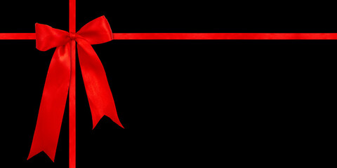 Gift wrapping design with red satin bow isolated on black background. Preparation for the holiday.