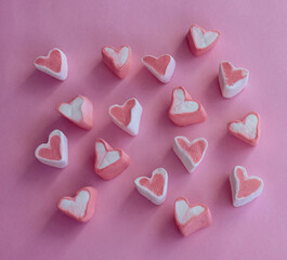 pink heart shaped candy pink background