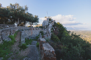 Fototapeta na wymiar View of Kaiser's Throne observation deck lookout, Pelekas village, Corfu island, Greece, Kaiser William II summit Observatory panoramic summer view with mountains and Kerkyra in the background