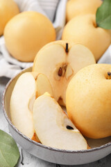 Naklejka na ściany i meble Delicious apple pears on white textured table, closeup